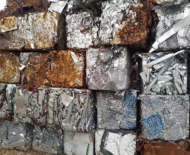 Waste metal scraps are baled for recycling